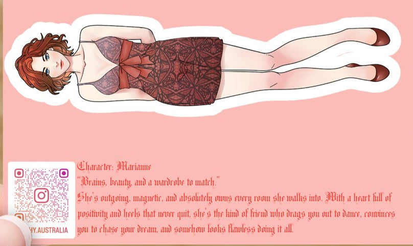 Sticker of a woman in a red dress with text on a pink card held by a hand against a wooden background